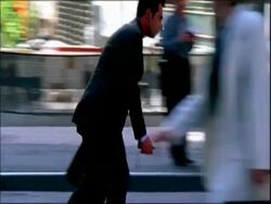 MS business man on rollerblades weaves in and out of traffic and pedestrians Stock Footage