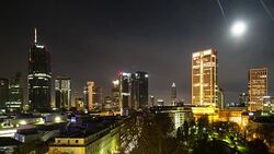 A night to day time lapse of central Frankfurt am Main, Germany, featuring a moonset occasionally obscured behind thin, wispy clouds Stock Footage