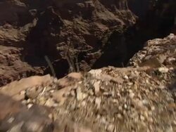 Multiple crane push-in - Rocky desert terrain plunges to a deep canyon crossed by fissures. / Arizona, USA Stock Footage
