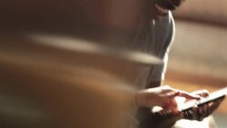 Couple on motel bed scroll and make plans with smartphone Stock Footage