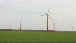 Colourful wind turbines operated by Nuon, near Almere in Flevoland, Netherlands. They are sited on reclaimed polder land that is below sea level. Stock Footage