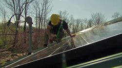 Solar panels being fitted to a building News Clip