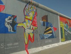 Jogger running in front of Berlin Wall, Grafitti, Murals, Stock Footage