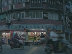 WS SLO MO Shot of small shops and restaurants, with bicycles and motorbikes passing by on narrow street in city / Shanghai, China  Stock Footage