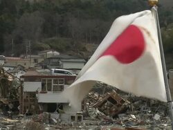 Japanese Flag flying in Onagawa town in in Oshika District, Miyagi, Japan on 3rd April 2011, 3 weeks after a tsunami hit North East Japan, caused by magnitude 9 Tohoku. Stock Footage