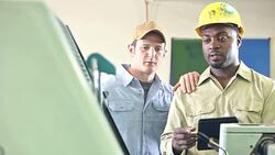 Two men working in printing shop with equipment Stock Footage