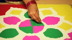 Young woman decorating rangoli in diwali festival, Delhi, India Stock Footage