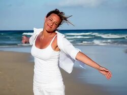 Woman spinning on beach Stock Footage