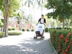 Mother and her baby are walking in the garden Stock Footage