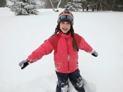 WS Girl playing with snow during snowstorm / Yarmouth, Maine, USA Stock Footage