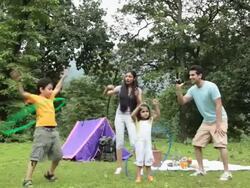 Family playing with hula hoop in a forest, Malshej Ghat, Maharashtra, India Stock Footage