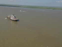 AERIAL WS Cargo ship flowing on river with helipad / New Orleans, Louisiana, United States Stock Footage