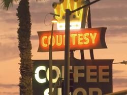 PAN TD neon sign of retro coffee shop diner against orange magic hour sky / Blythe,California, USA  Stock Footage