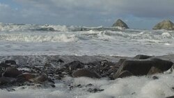 Slow motion of waves crashing on rocks at the beach Stock Footage