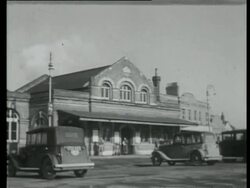 Railway station building with cars, United Kingdom, 1939 Stock Footage