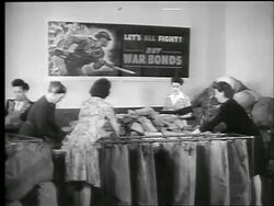 B/W 1944 group of women sorting stacks of envelopes into large mail bags War Bond office / WW II Stock Footage