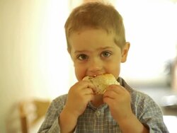 Little boy eating a slice of bread Stock Footage