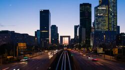 Paris road leading towards La Grand Arche and modern office buildings at La Defense, Paris, France - Time lapse Stock Footage
