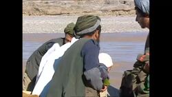 Afghans crossing river on homemade rafts News Clip