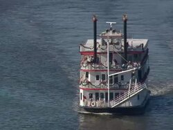 MS AERIAL ZO Shot of Riverboat Georgia Queen moving in river and cars moving on bridge / Georgia, United States Stock Footage