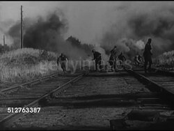 1944: RETREATING DESTRUCTION: LA WS German Nazi Soldiers setting charges to railroad tracks, tracks exploding BG as Germans move forward. Instructional Video