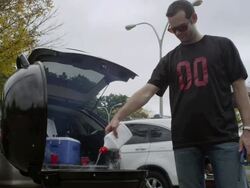 MS Man spraying lighter fluid into grill causing smoke and flames to coming out / Valhalla, New York, United States Stock Footage