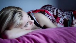 Woman texting in bed Stock Footage