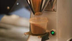 Automated coffee grinder filling container Stock Footage