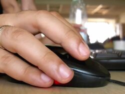 Hand clicking computer mouse Stock Footage