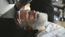 Barber hand wash head elderly clients Stock Footage