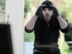 Burglar peering through window, laptop in foreground  Stock Footage