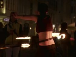 MS PAN Female fire dancer dancing with flaming hula hoop instreet at night / Dresden, Saxony, Germany Stock Footage