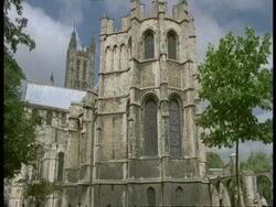 Canterbury Cathedral, Kent - 2 people walk past in foreground Stock Footage