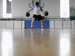 WS  young man practicing his dribbling of basketball inside  gymnasium / Minneapolis, Minnesota, United States  Stock Footage