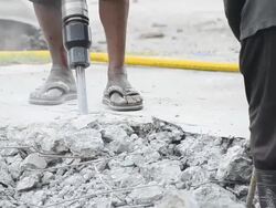 Worker With Jackhammer Digging Up Concrete Road Stock Footage