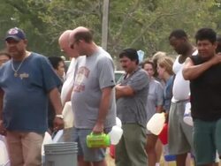 MS PAN Shot of people holding gas cans and waiting in line for fuel as Hurricane Rita approaching Texas / Texas, United States Stock Footage