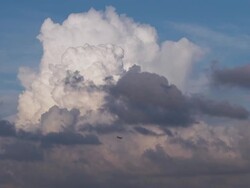 View of flying airplane and cumulus clouds Stock Footage