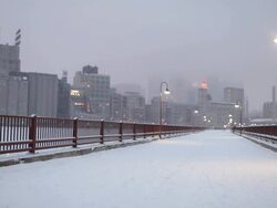 WS View of Stone Arch Bridge in winter with snow on it / Minneapolis, Minnesota, United States Stock Footage