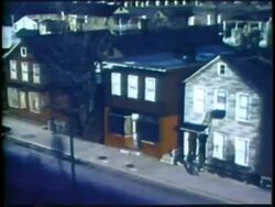 1973 MONTAGE HA WS PAN Business district of city to poor area/ WS poor area of city/ USA/ AUDIO Stock Footage
