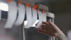 Restaurant chef takes order ticket down and spikes it on check spindle in kitchen. Stock Footage