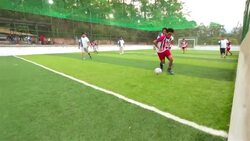 Man slides into attack on goal, misses, and rolls over in local soccer match Stock Footage