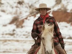 MS Cowgirl riding on a horse trotting across field / Shell, Wyoming, United States Stock Footage
