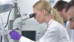 MS DS Female Scientist Looking Into Microscope Stock Footage