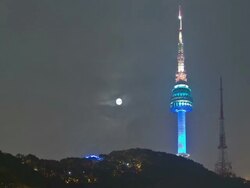 WS T/L Night scenery of N seoul tower and full moon rising in  sky / Seoul, South Korea Stock Footage