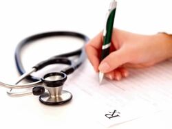 Close-up of stethoscope and doctor's hand writing a medical prescription Stock Footage