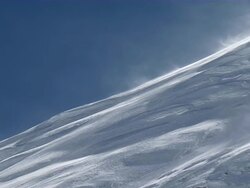MS Snow blowing with wind on snow covered side to peak of mount everest with blue sky / Mt. Everest, Nepal Stock Footage