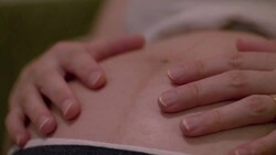 CU,Hands of pregnant woman caressing her belly. Stock Footage