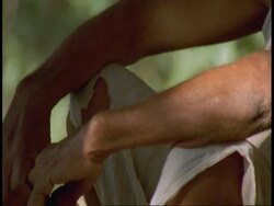 CU tilt up from hand to Hindu Priest sitting in Temple ruin, Bandhavgarh National Park, India Stock Footage