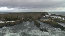 Waves crash onto a rocky, snowy island in Nova Scotia. Stock Footage