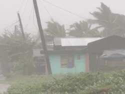 Houses and trees lashed by hurricane force winds of typhoon Megi or Juan in Philippines. Super Typhoon Megi or Juan, NE Luzon, Philippines Oct 2010 / AUDIO Stock Footage
